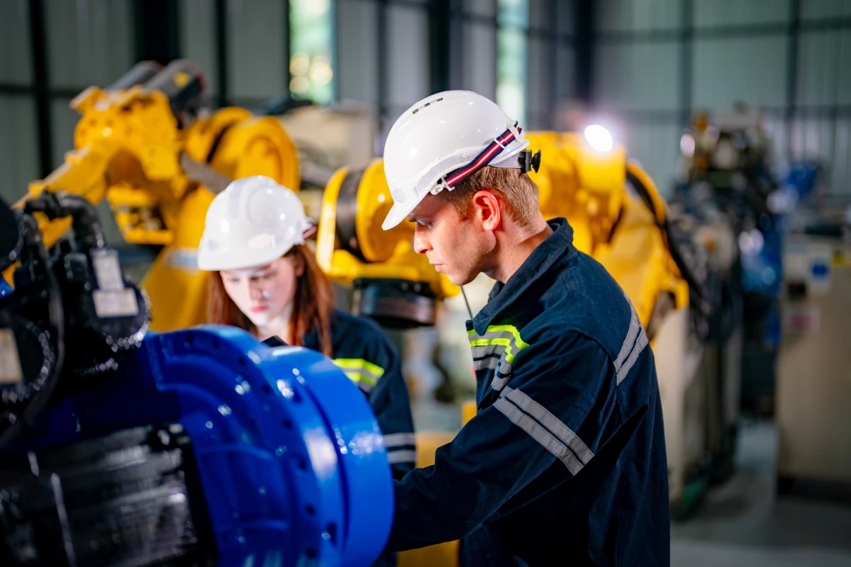 two construction workers using large machinery
