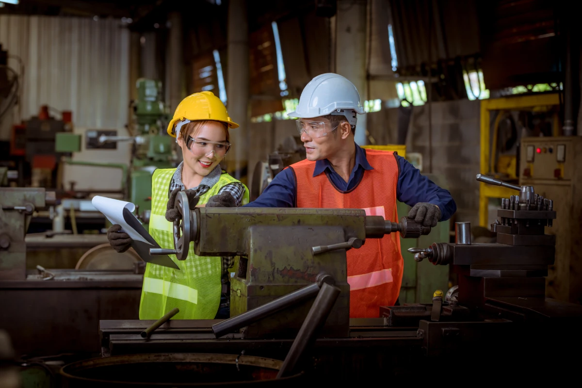 two construction workers using large machinery
