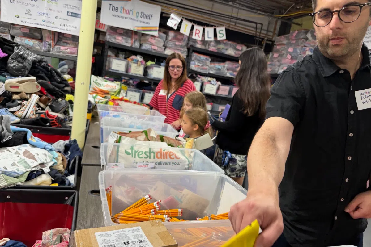 Adam C. Weiss and Amy from Lever & Ecker volunteering at the Sharing Shelf event in Port Chester