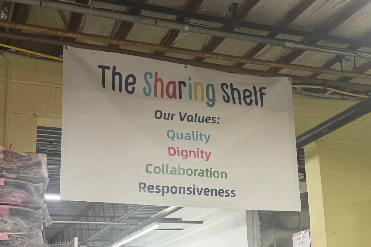 a picture of The Sharing Shelf sign at a volunteer event in Port Chester
