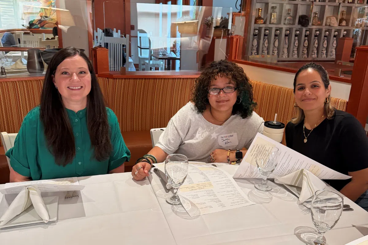 Kate, Geraldine, and the Lever & Ecker team eating after a volunteer event at The Sharing Shelf in Port Chester