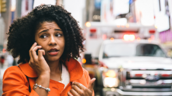 a woman calling the police to report a car accident in new york