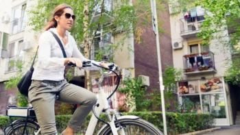 a woman riding an e bike in new york city